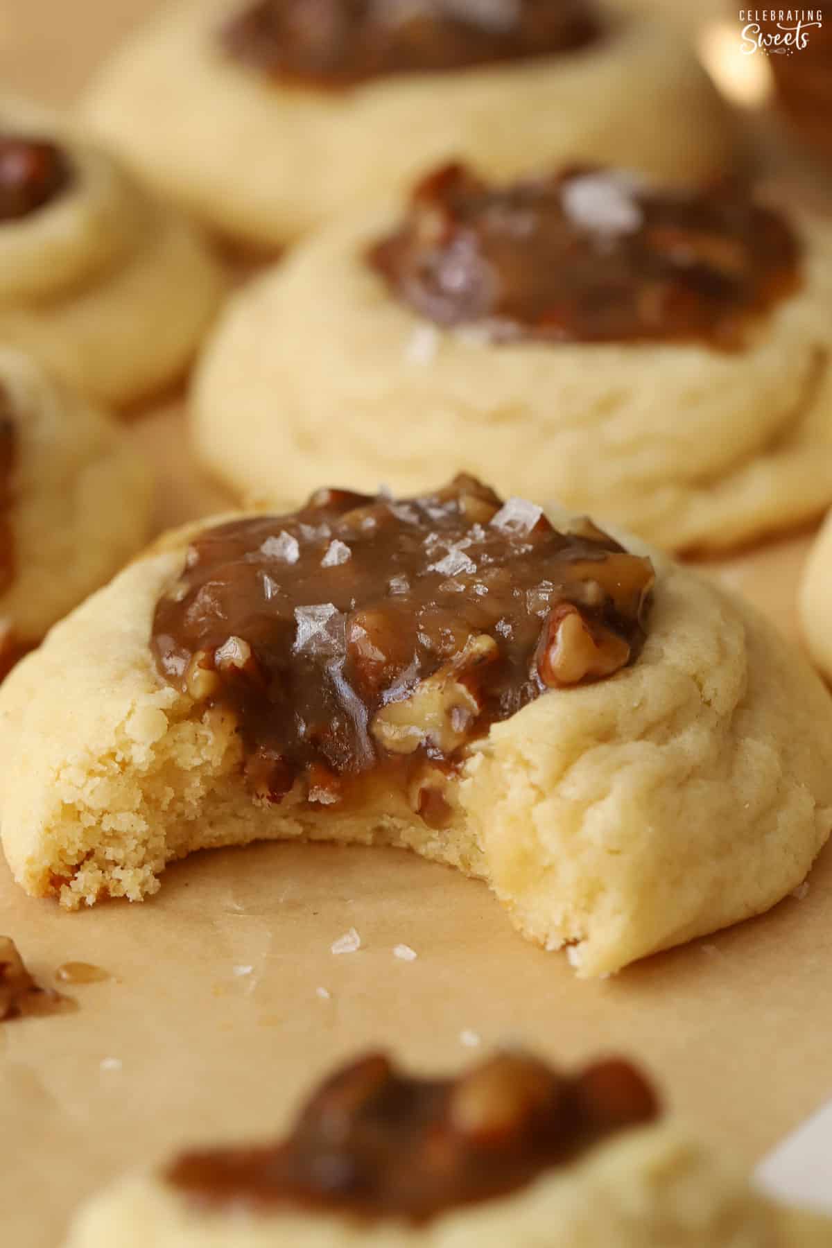 Pecan pie cookie with a bite taken out of it.