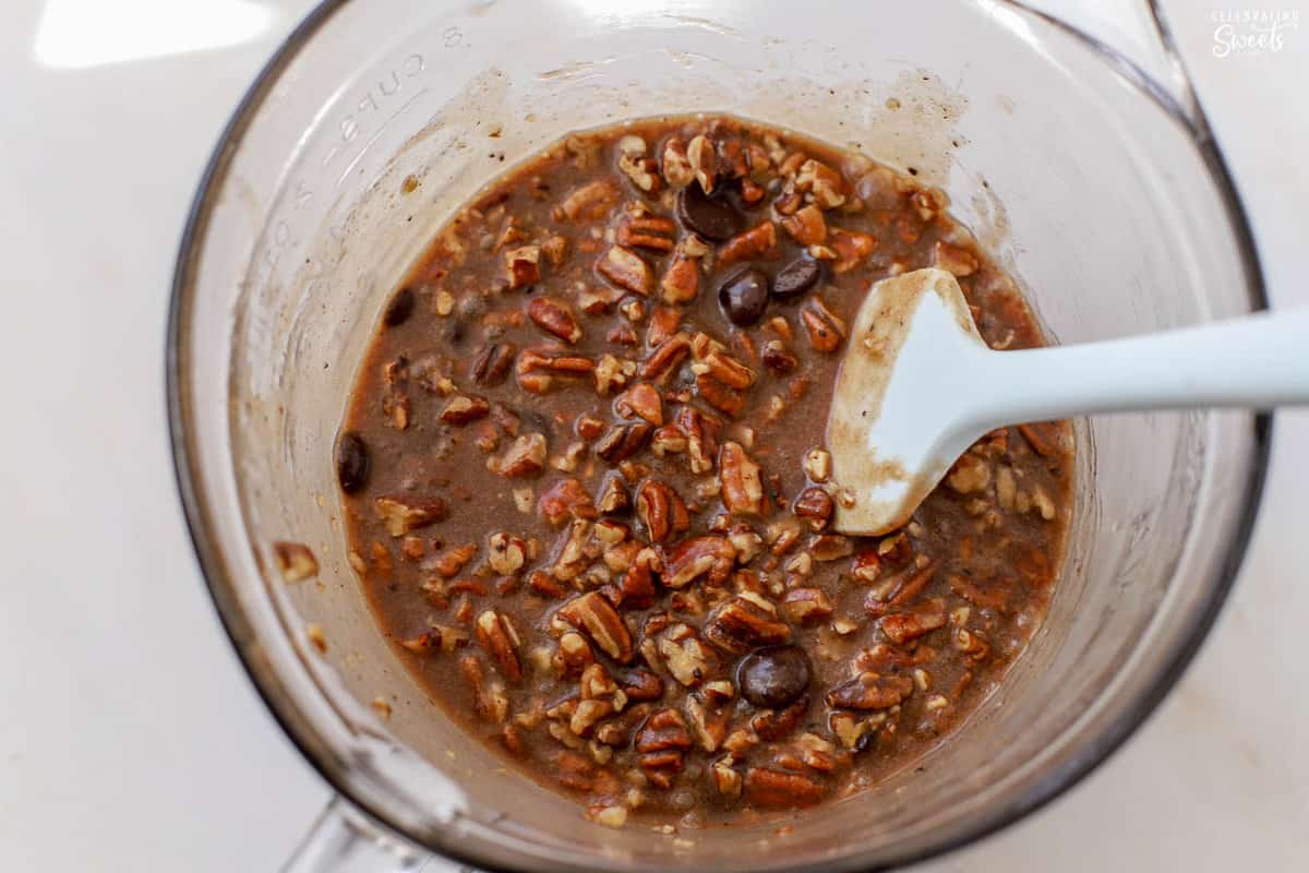 Uncooked chocolate pecan filling in a glass bowl.