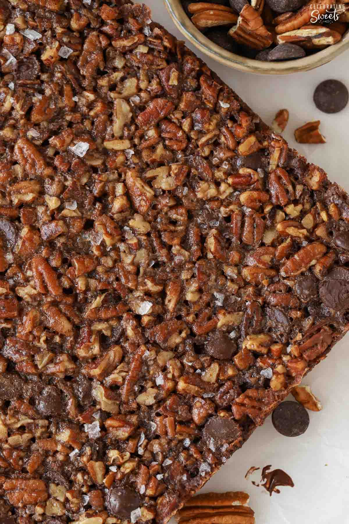 Chocolate pecan pie bars topped with flaky sea salt.