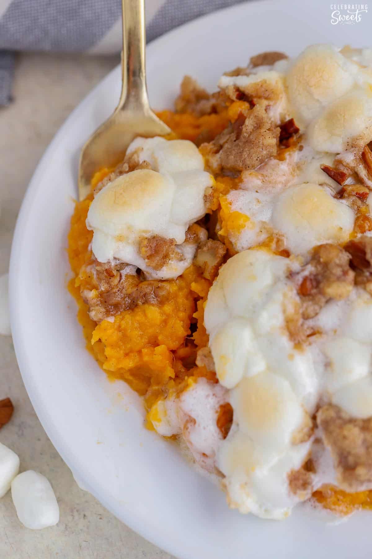 Closeup of sweet potato casserole on a white plate.