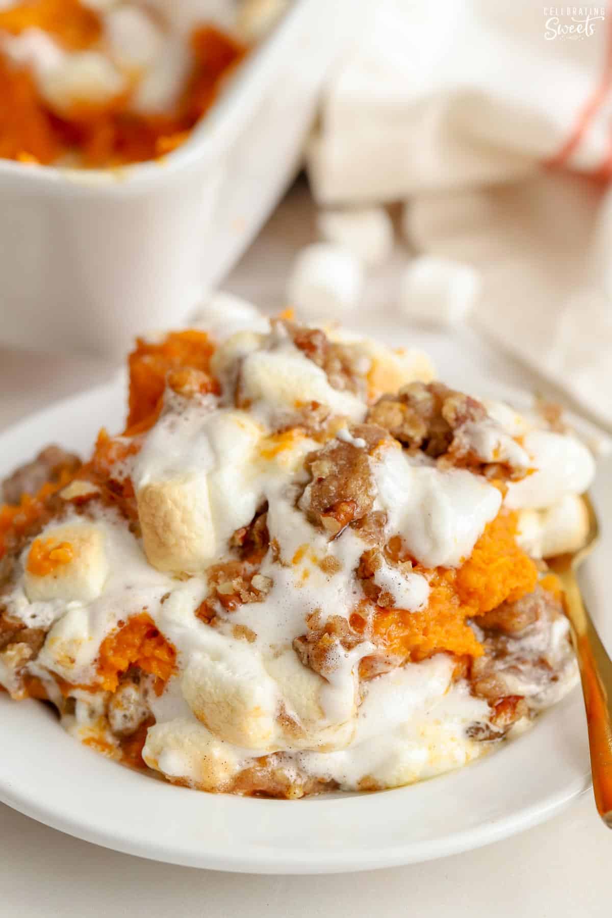 Closeup of sweet potato casserole on a white plate.