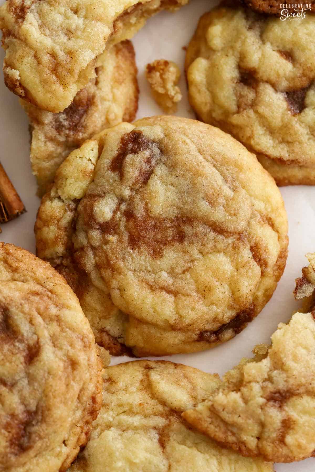 Closeup of cinnamon roll cookies on parchment paper.