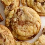 Closeup of cinnamon roll cookies on parchment paper.