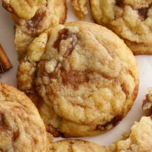 Closeup of cinnamon roll cookies on parchment paper.