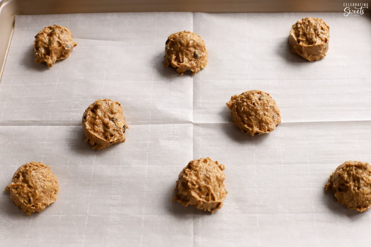Scoops of healthy chocolate chip cookie dough on a baking sheet.