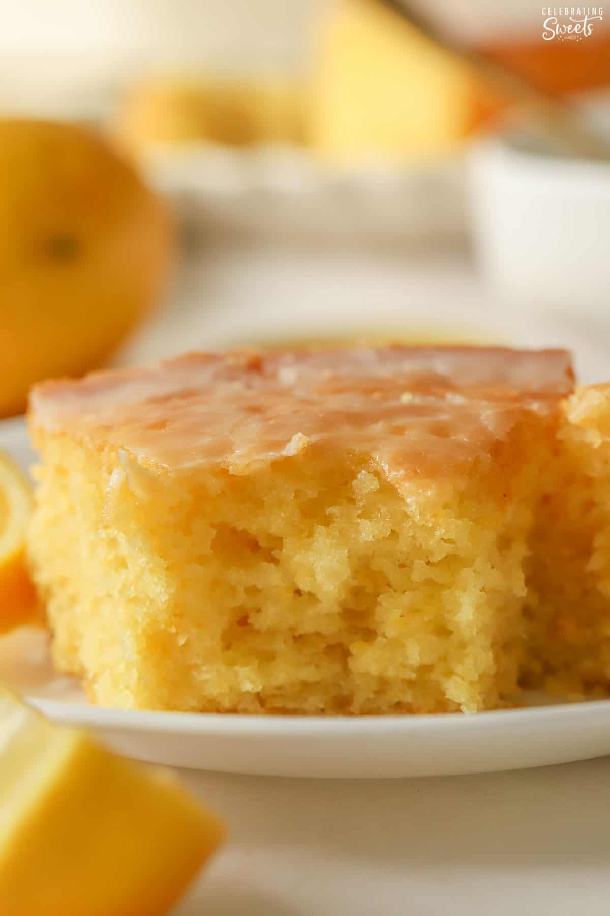Slice of lemon olive oil cake on a white plate.