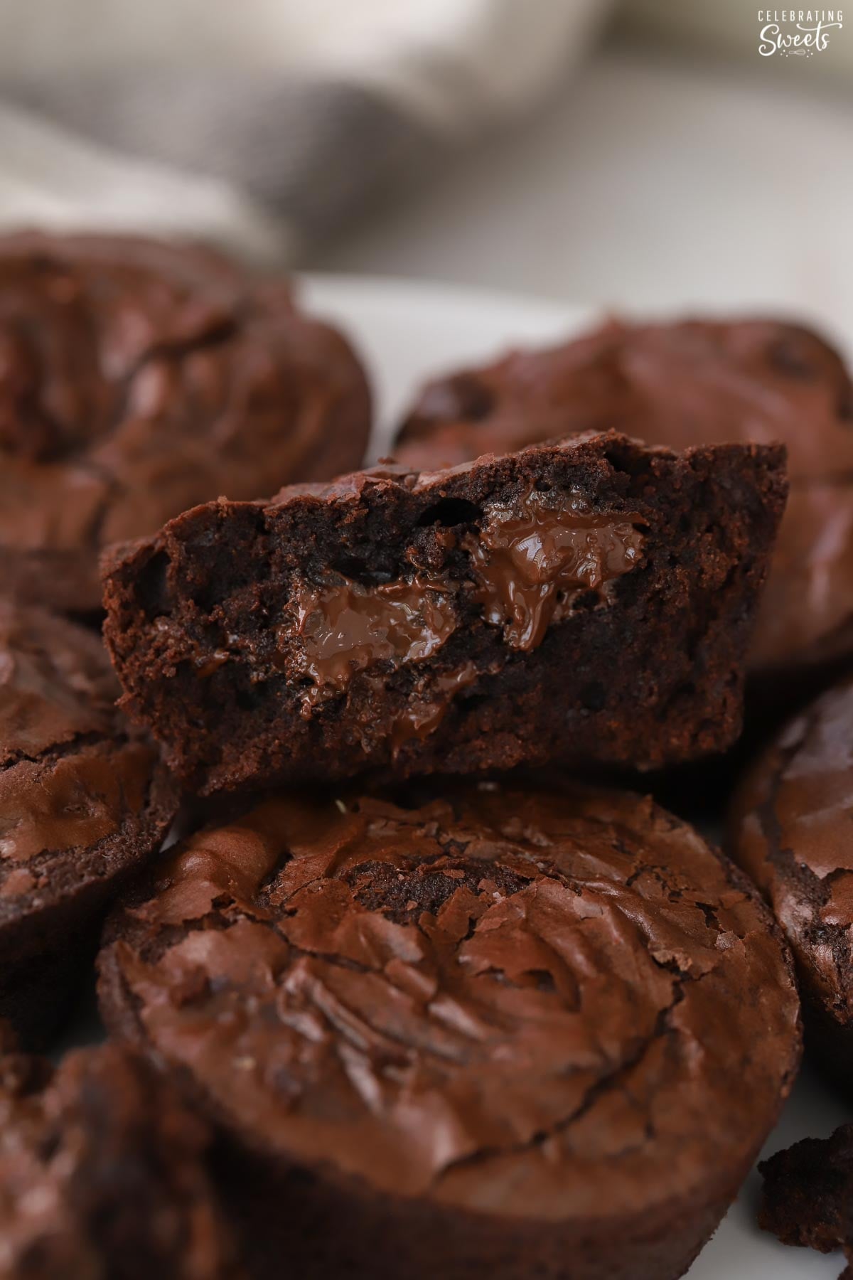 Closeup of half a brownie with melted chocolate inside.