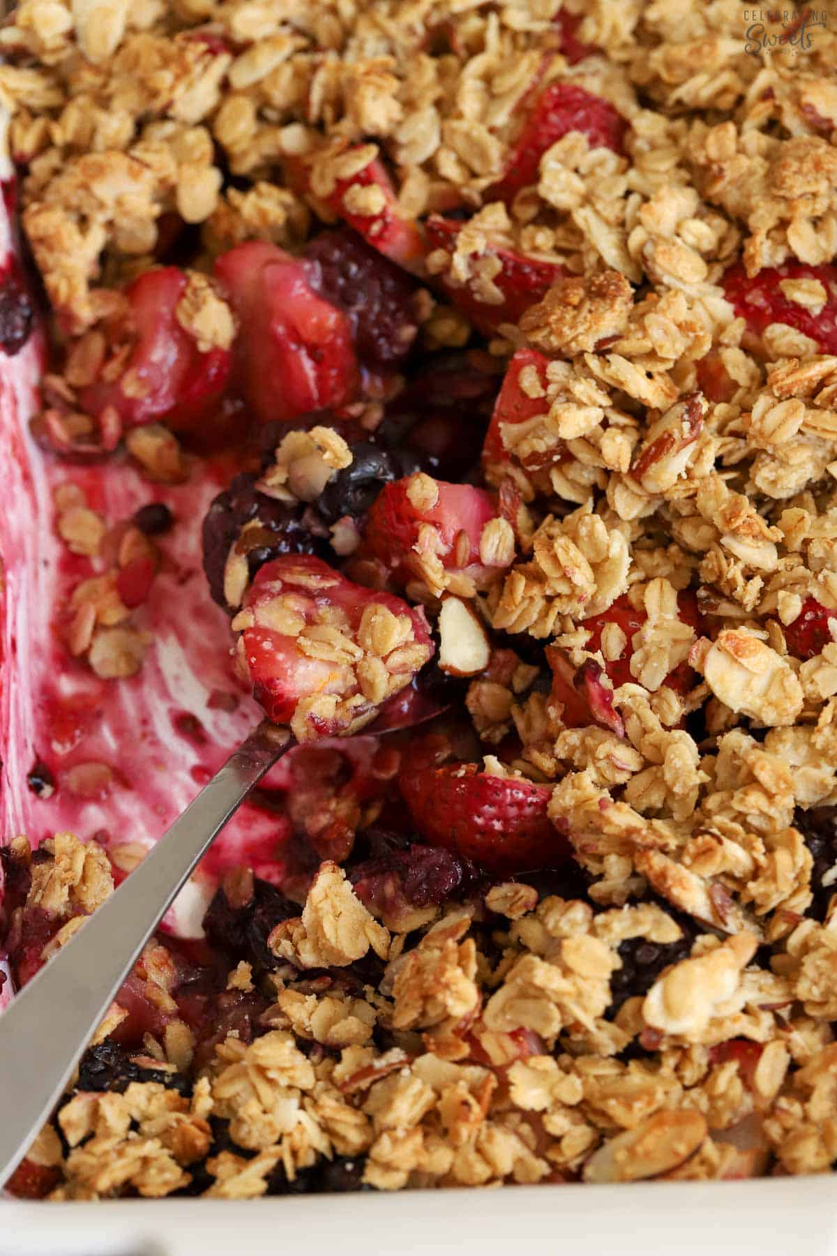 Closeup of berry crisp in a white dish.