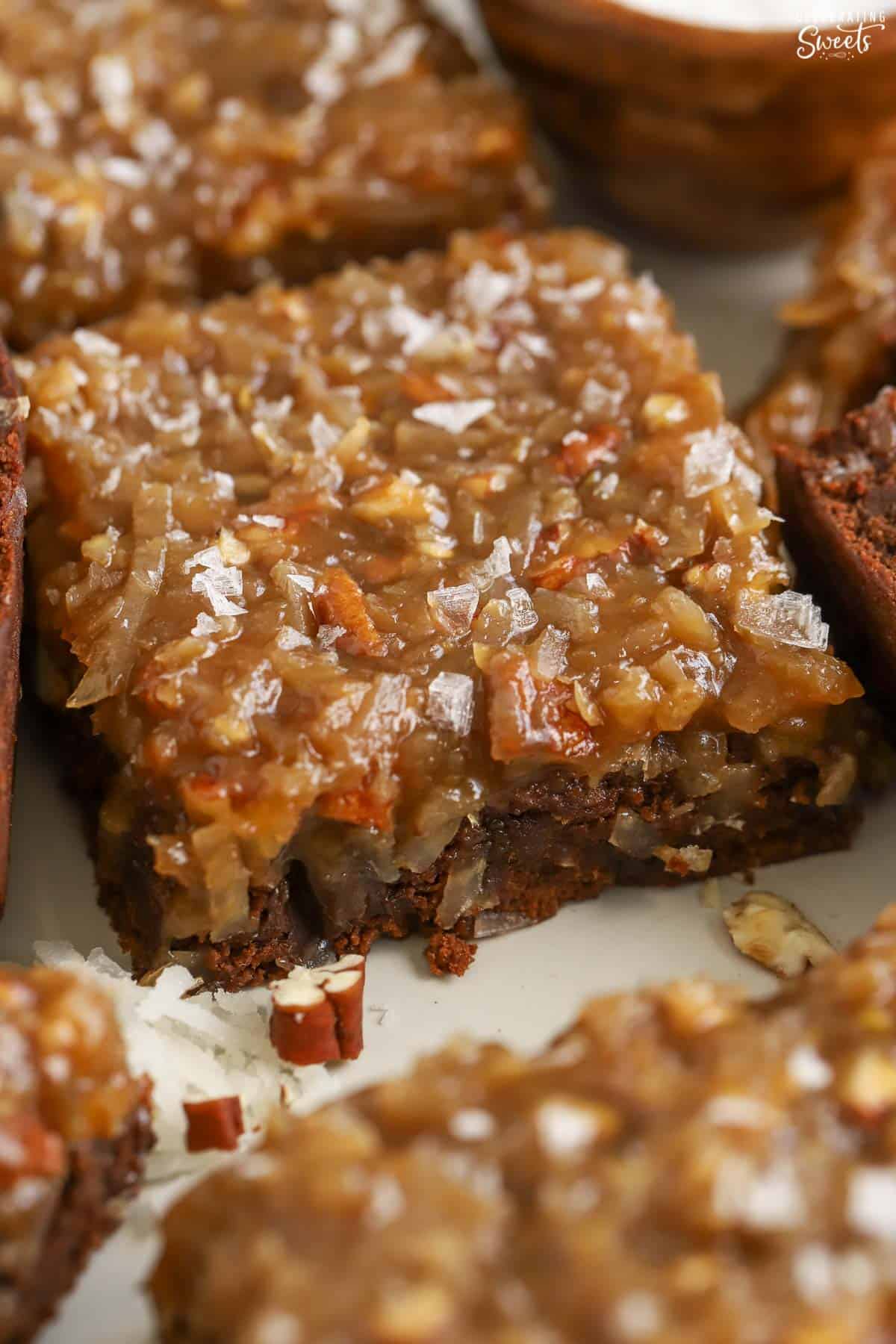 Closeup of a German chocolate brownie topped with flaky sea salt.