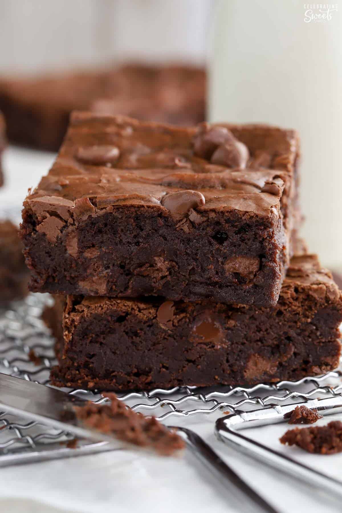 Stack of two homemade brownies on a wire rack.