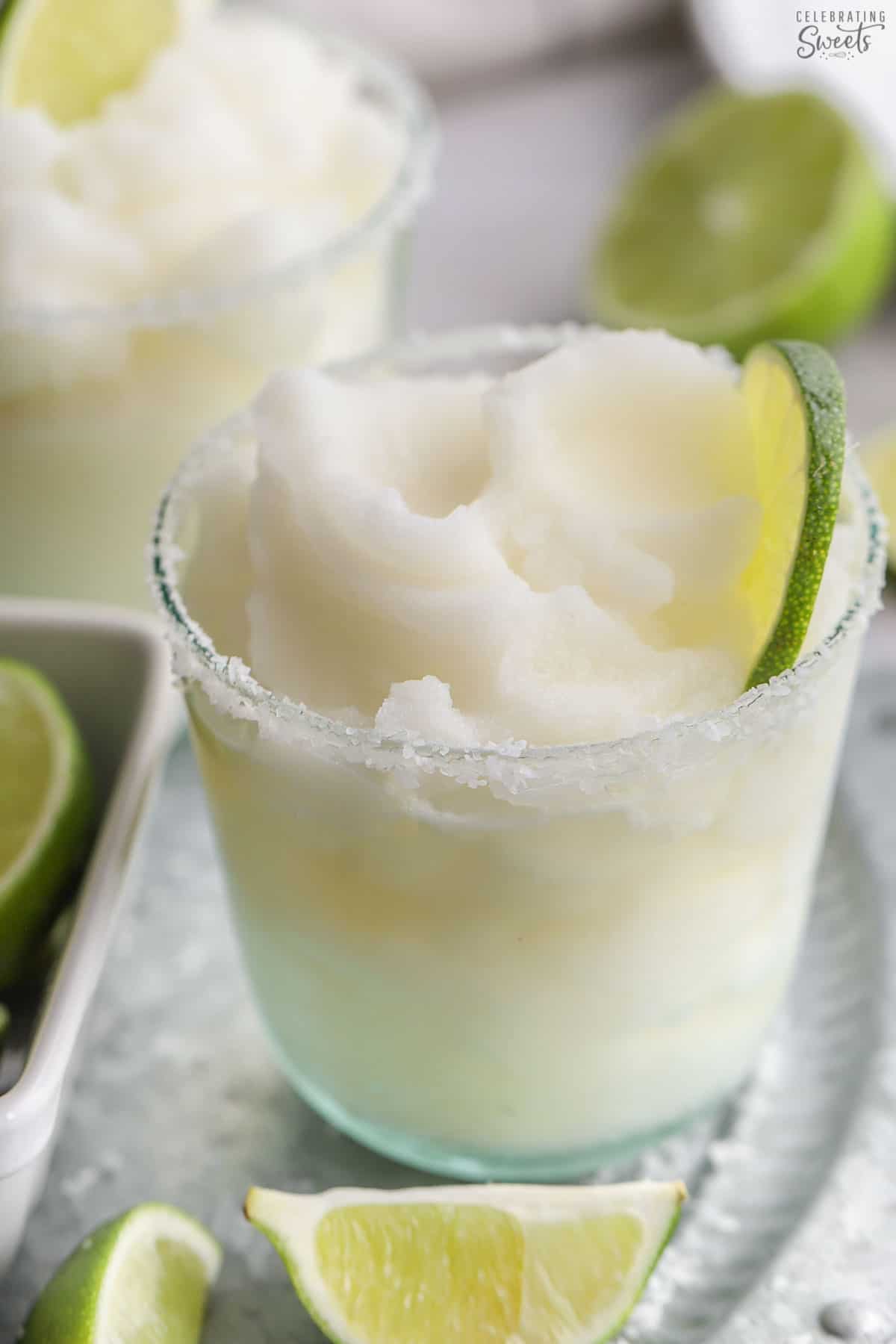 Frozen margarita in a glass on a silver platter.