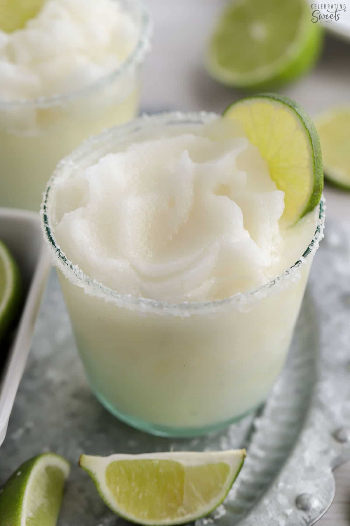 Frozen margarita in a glass on a silver platter.