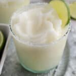 Frozen margarita in a glass on a silver platter.
