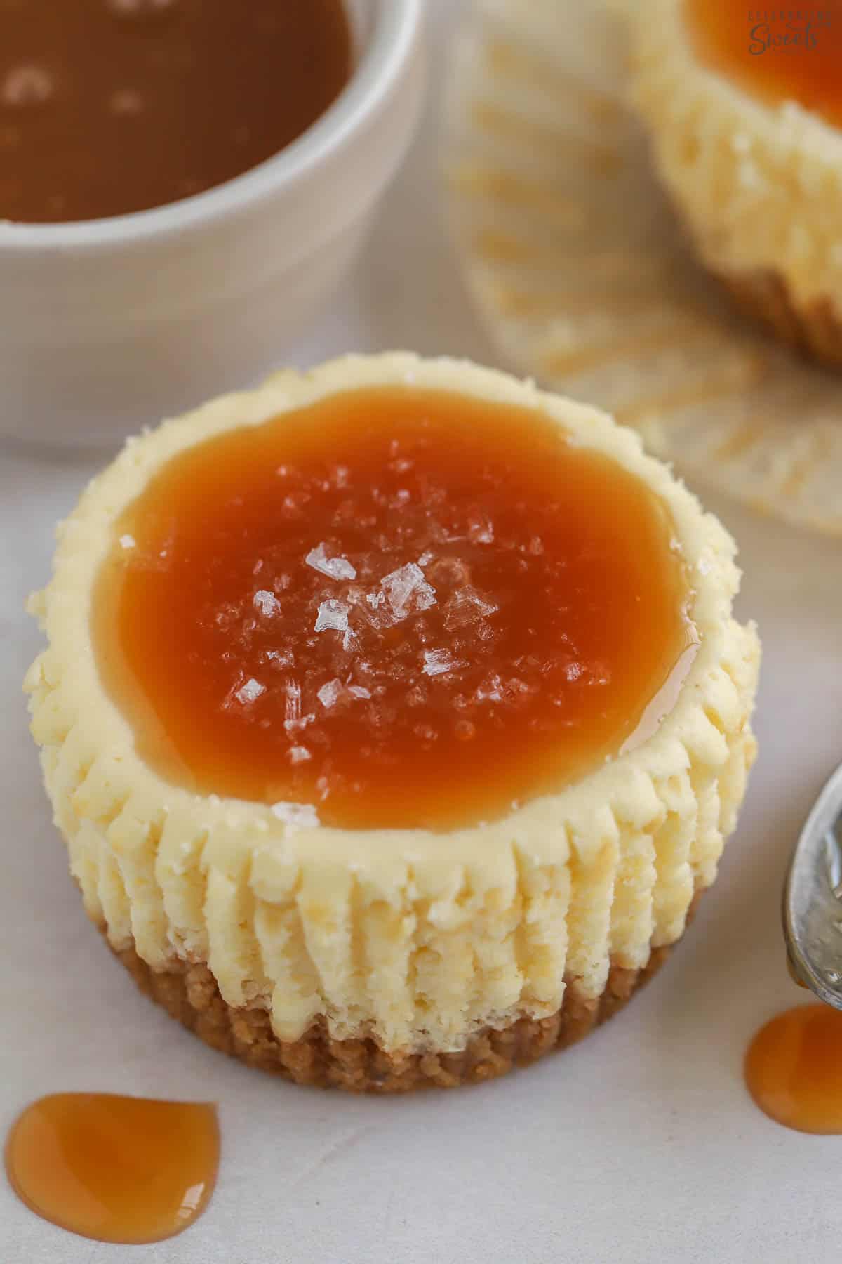 Caramel and flaky sea salt on a mini cheesecake.