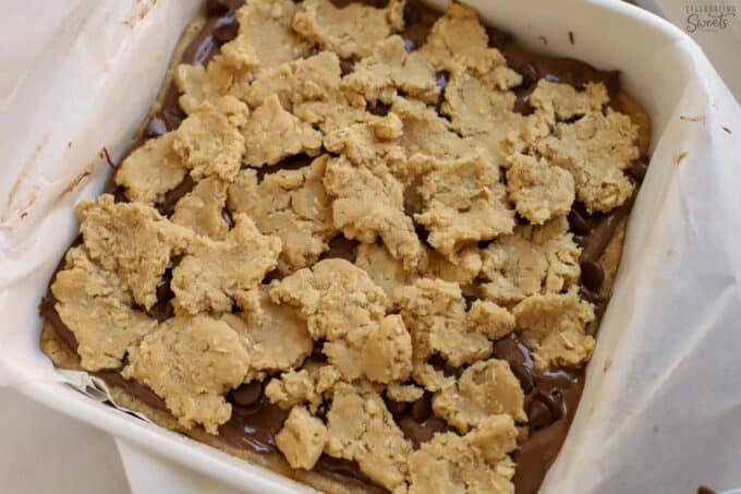 Unbaked nutella cookie bars in a white square baking dish.