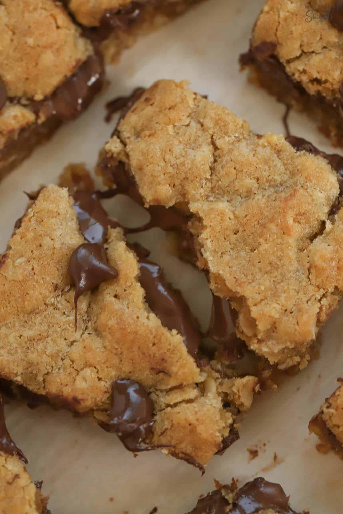 Nutella cookie bar split in half on a piece of parchment.