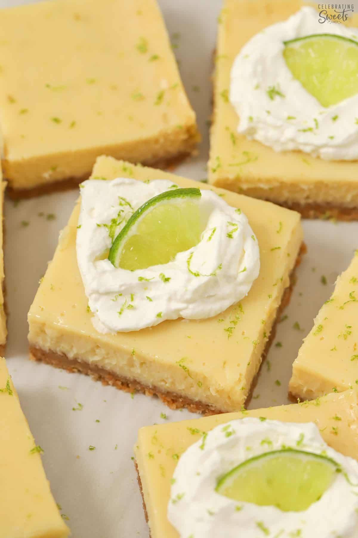 Key lime pie bars on parchment paper.