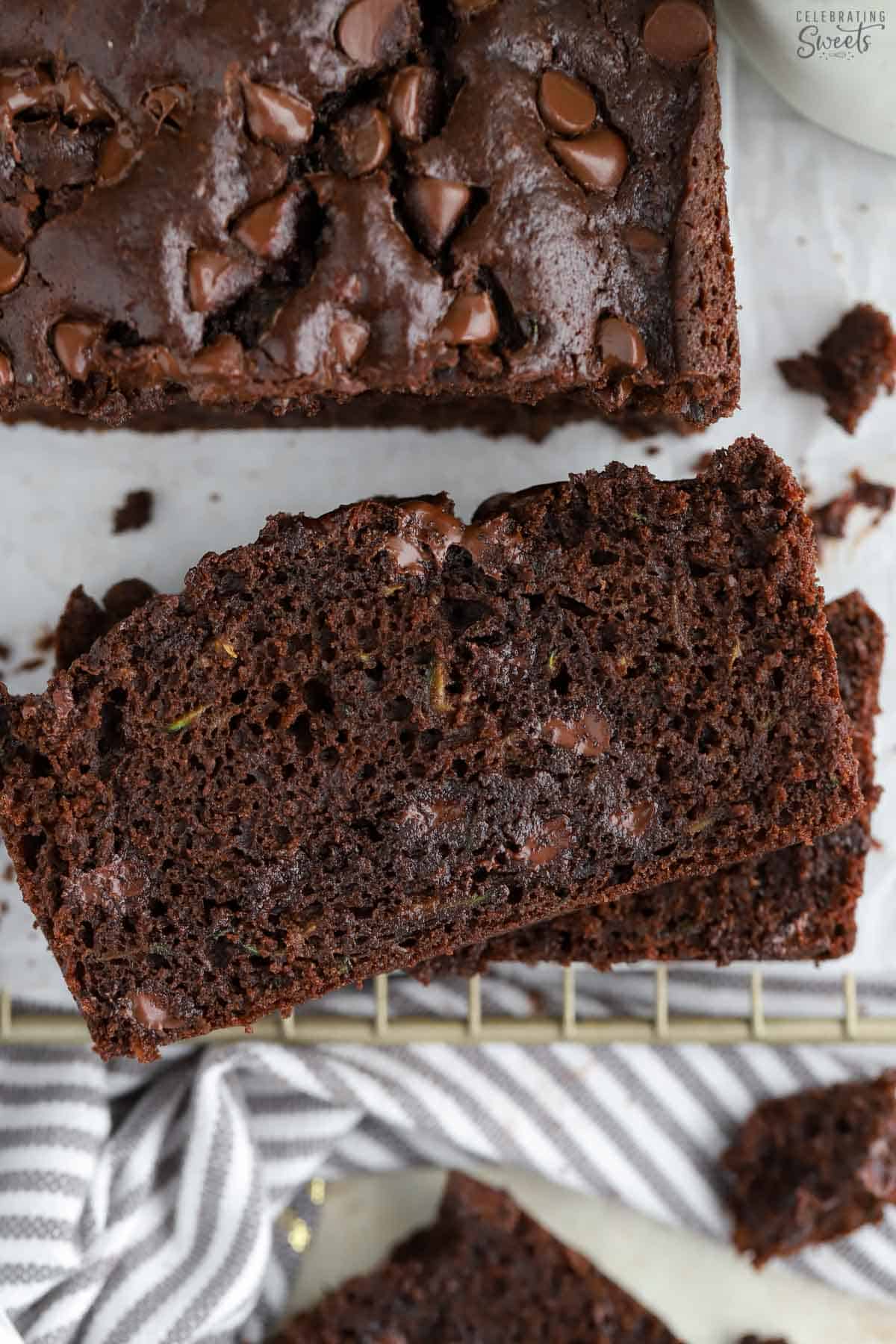 Slices of chocolate zucchini bread on a wire rack.
