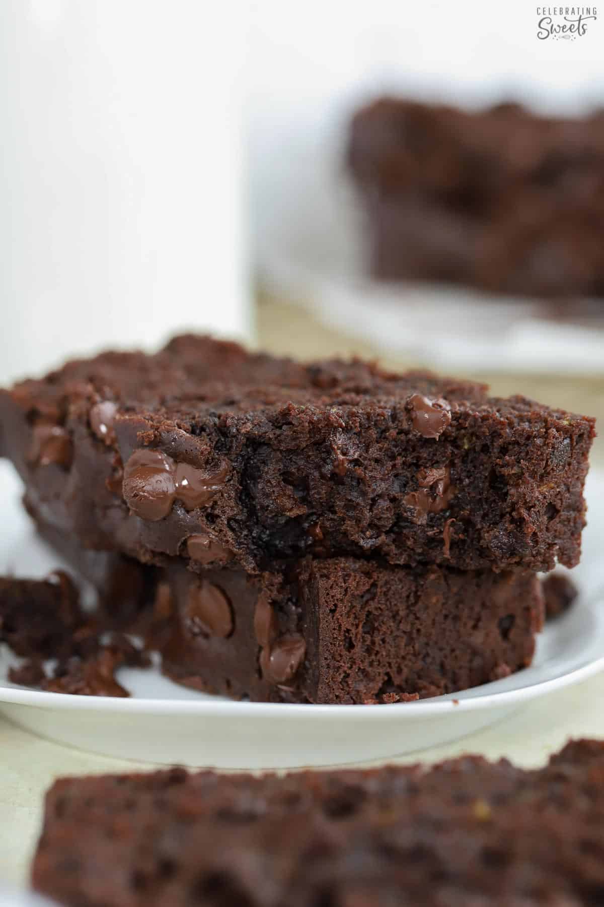 Two slices of chocolate zucchini bread on a white plate.