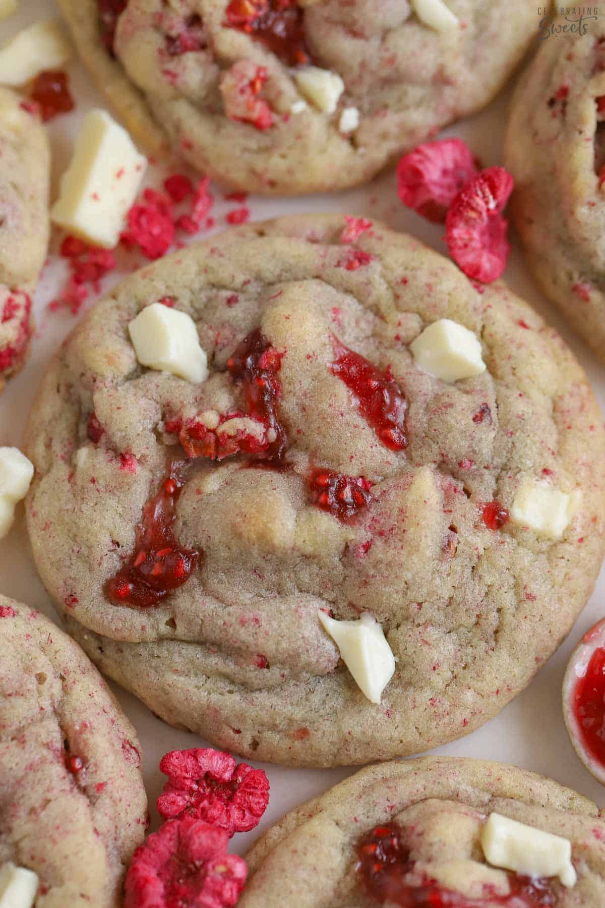 White chocolate raspberry cookie on a piece of parchment paper.