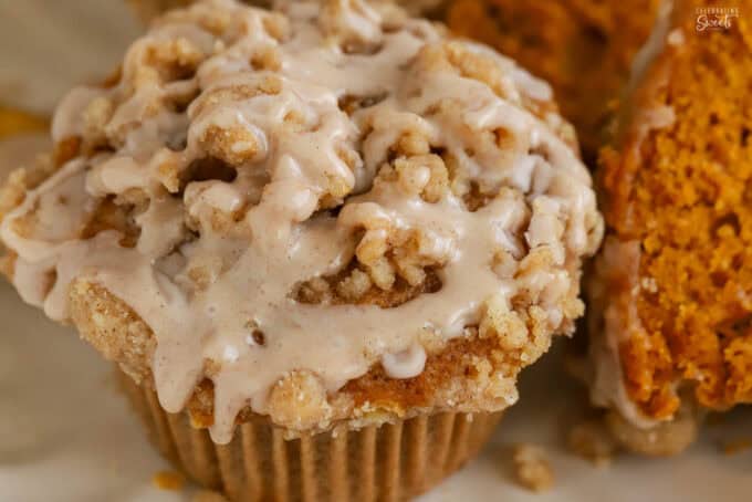 Overhead shot of a pumpkin muffin drizzled with cinnamon icing.