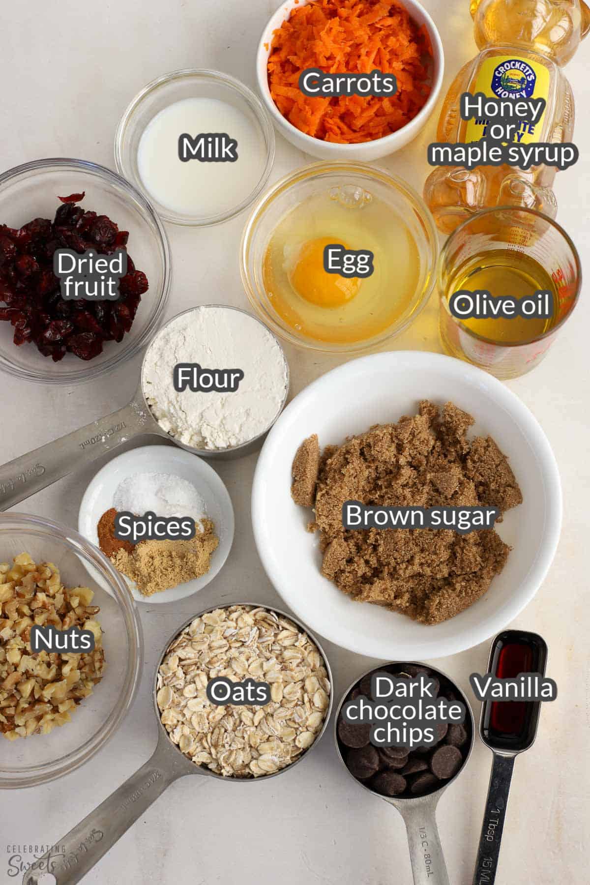 Ingredients for breakfast bars: oats, brown sugar, flour, dried fruit, nuts, chocolate chips, spices, egg, oil, vanilla.