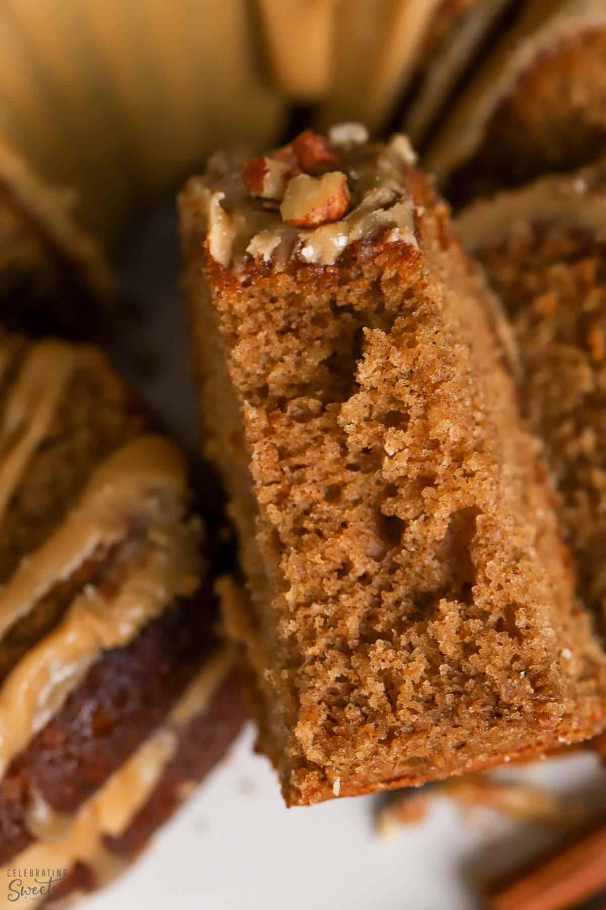 Closeup of a slice of spice cake with maple glaze.