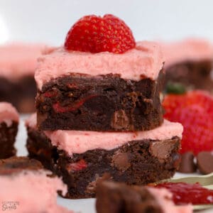 Two strawberry brownies stacked on top of each other.