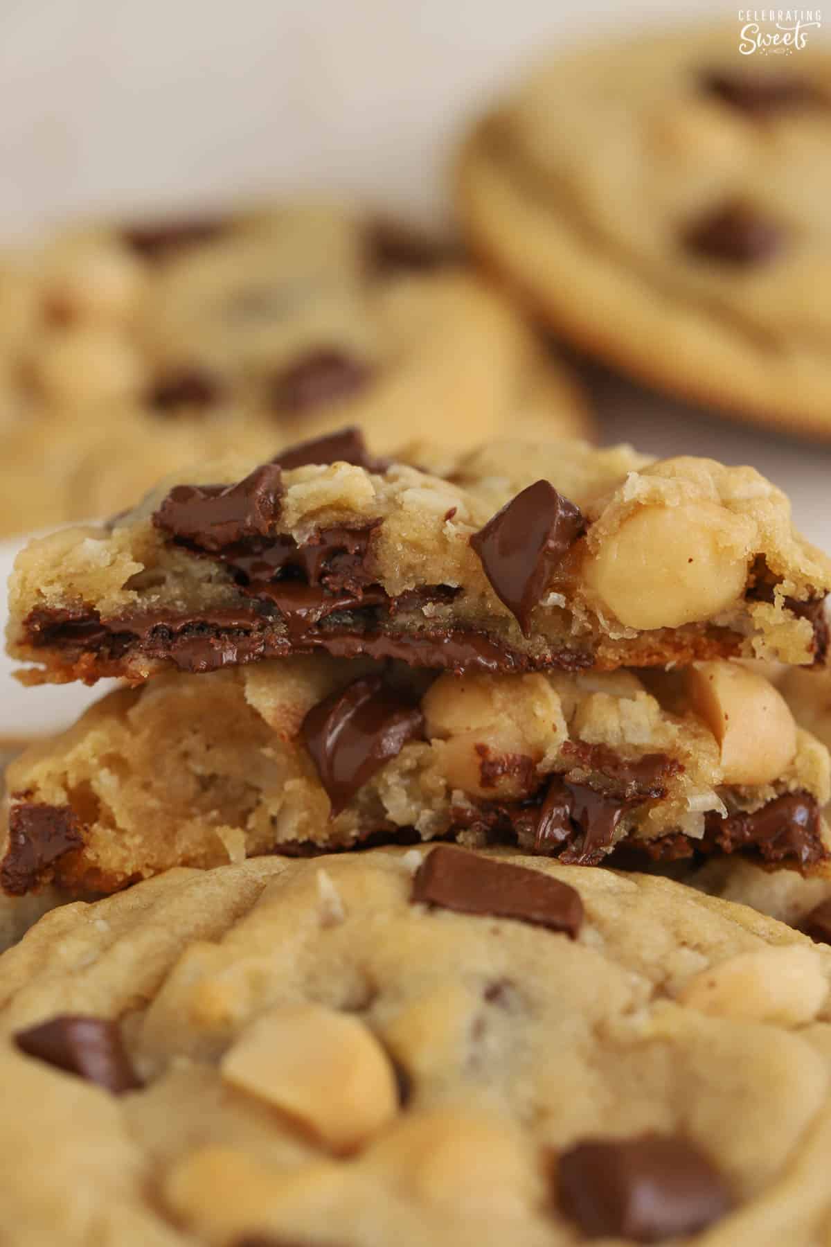 Two halves of a coconut chocolate chip cookie stacked on top of each other.