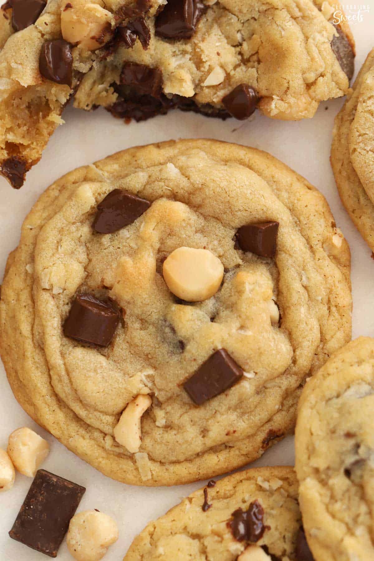Close up of a coconut chocolate chip cookie on parchment paper.