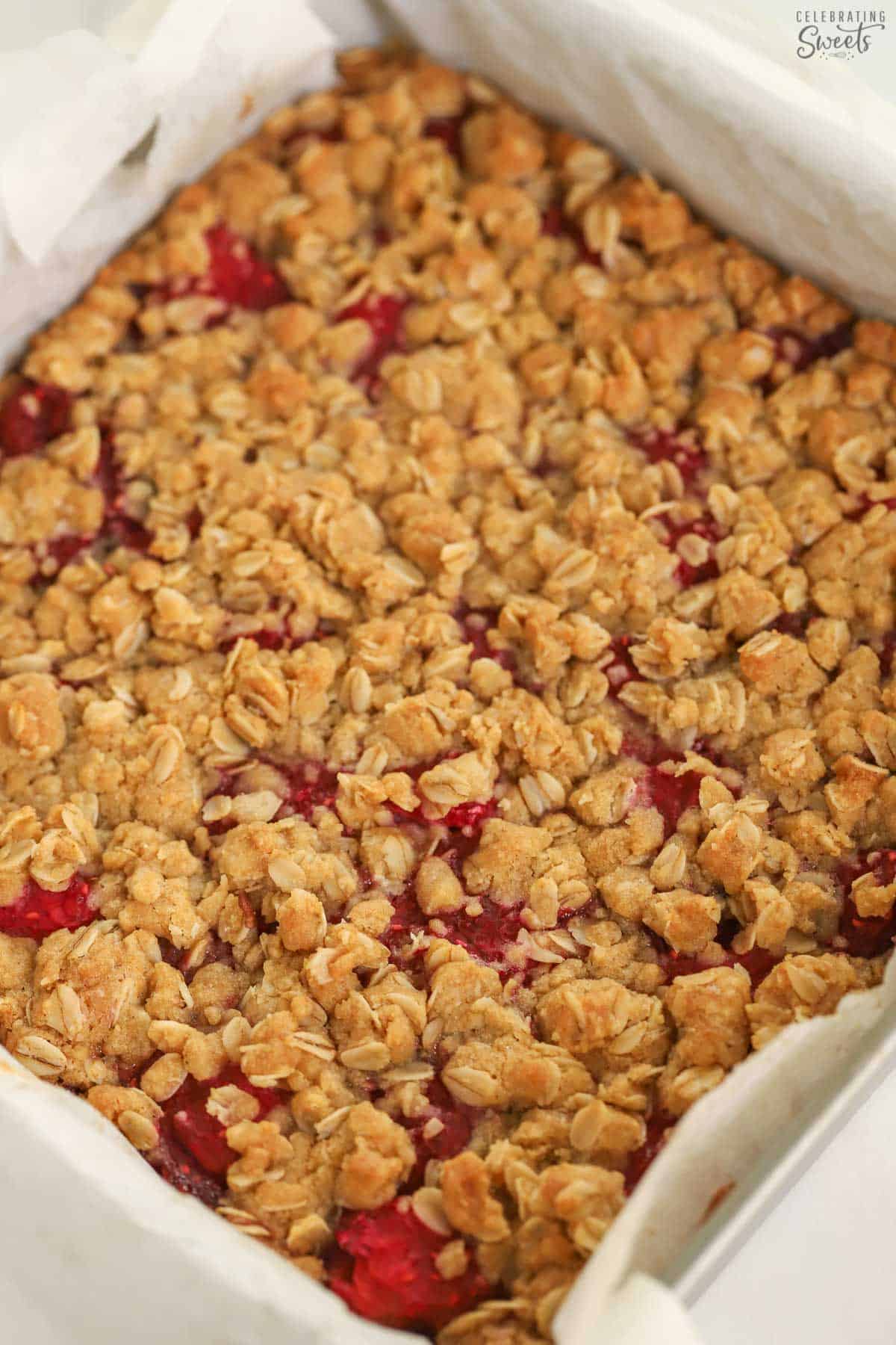 Raspberry bars in a foil-lined square baking pan.