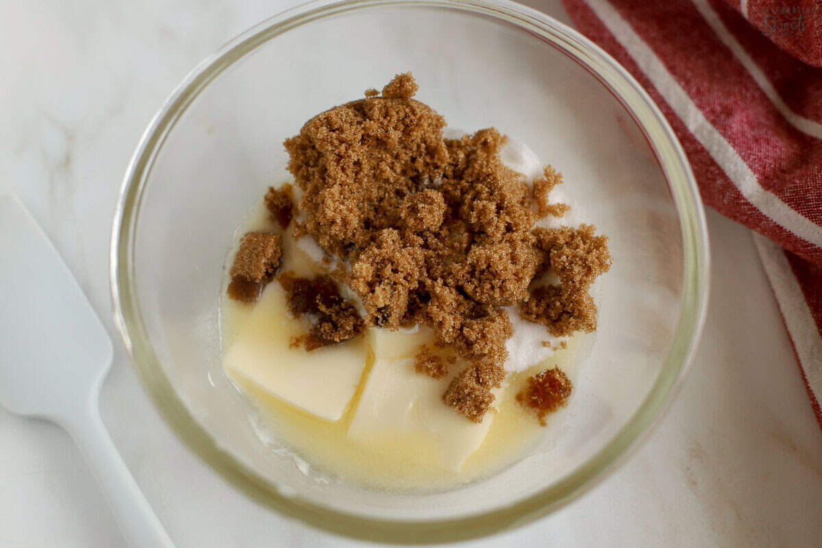 Butter and brown sugar in a glass bowl.