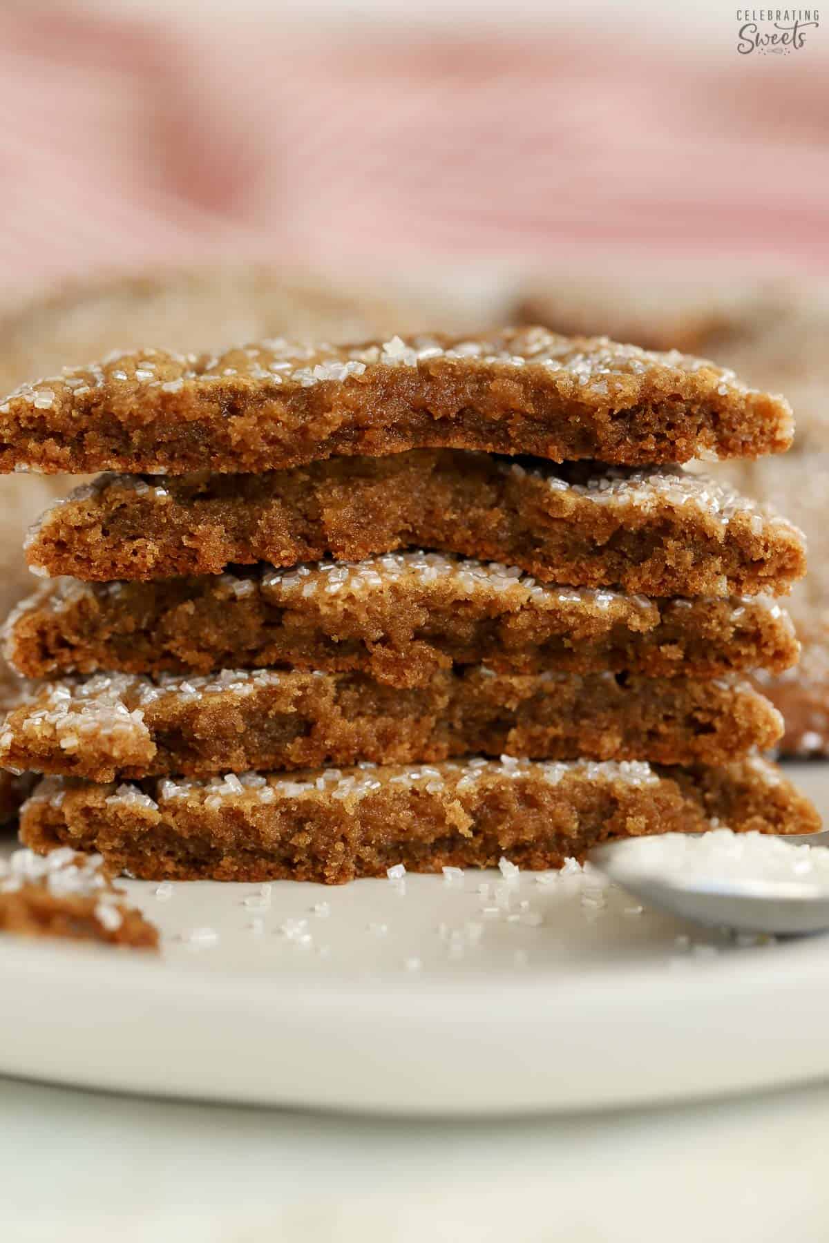 Stack of five halved ginger molasses cookies on a white plate.