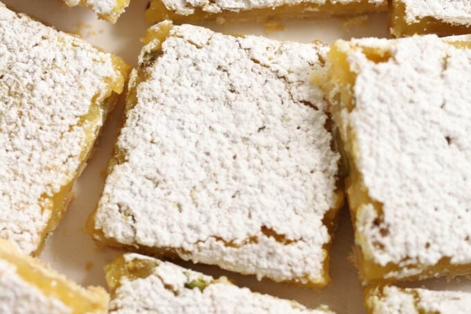 Lemon pistachio bars topped with powdered sugar.