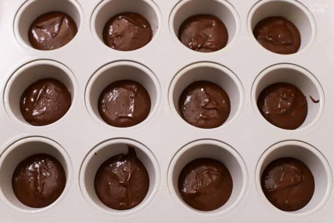 Brownie batter in a muffin pan.