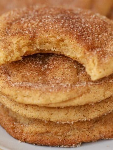 Stack of four snickerdoodle cookies on a grey plate.