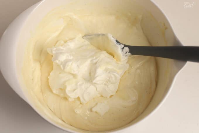 No-churn vanilla ice cream batter in a white bowl with a grey spatula.