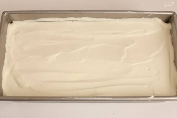 Vanilla ice cream in a rectangular metal loaf pan.