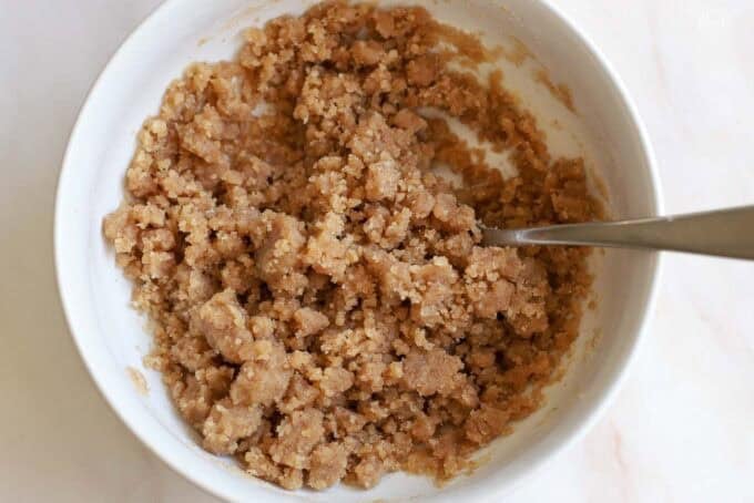 Unbaked crumb topping in a white bowl.