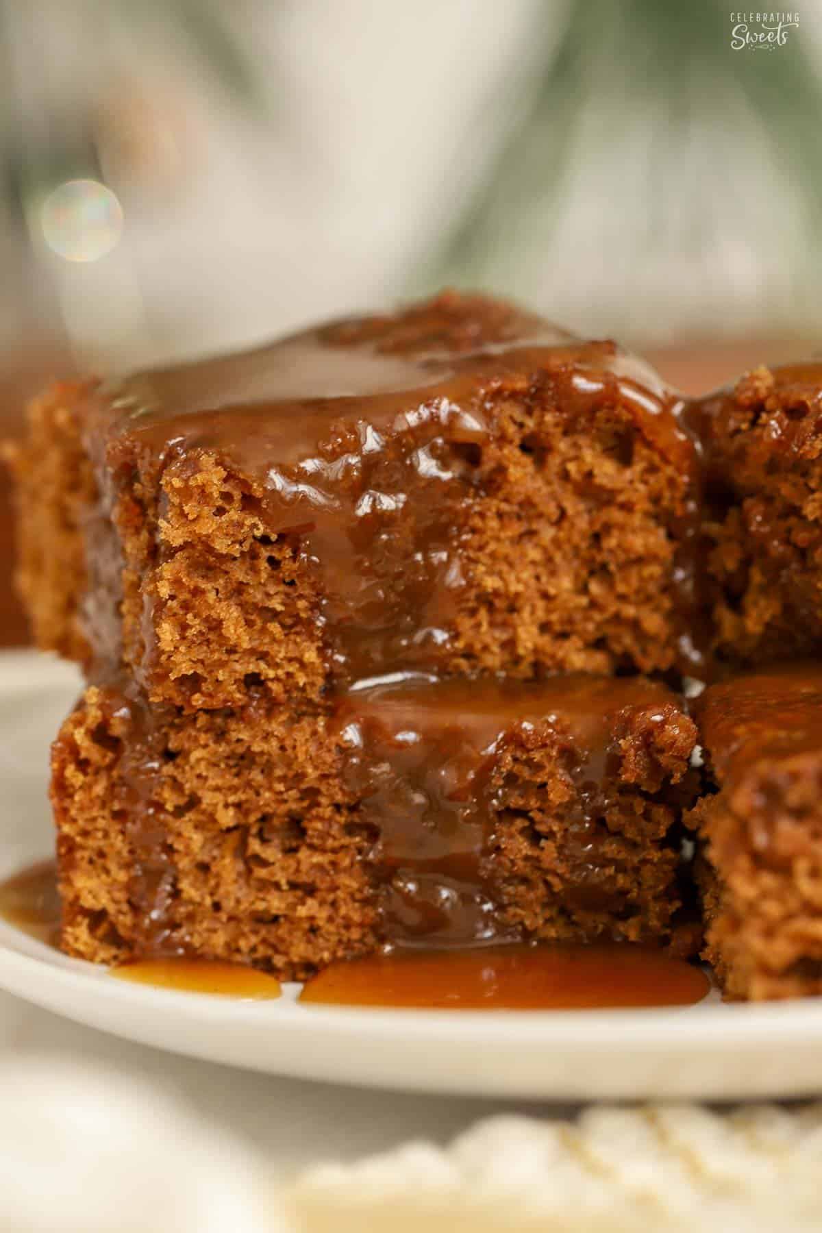 Gingerbread cake slices stacked on top of each other covered in toffee sauce.