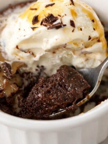 Brownie pudding topped with vanilla ice cream and caramel sauce.