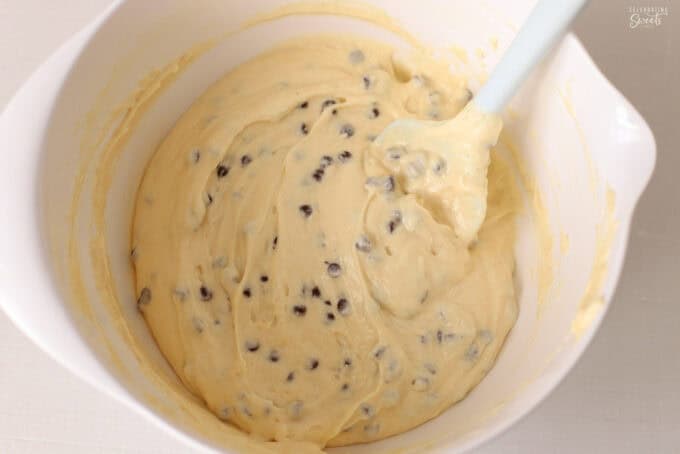 Cake batter filled with chocolate chips in a white bowl.