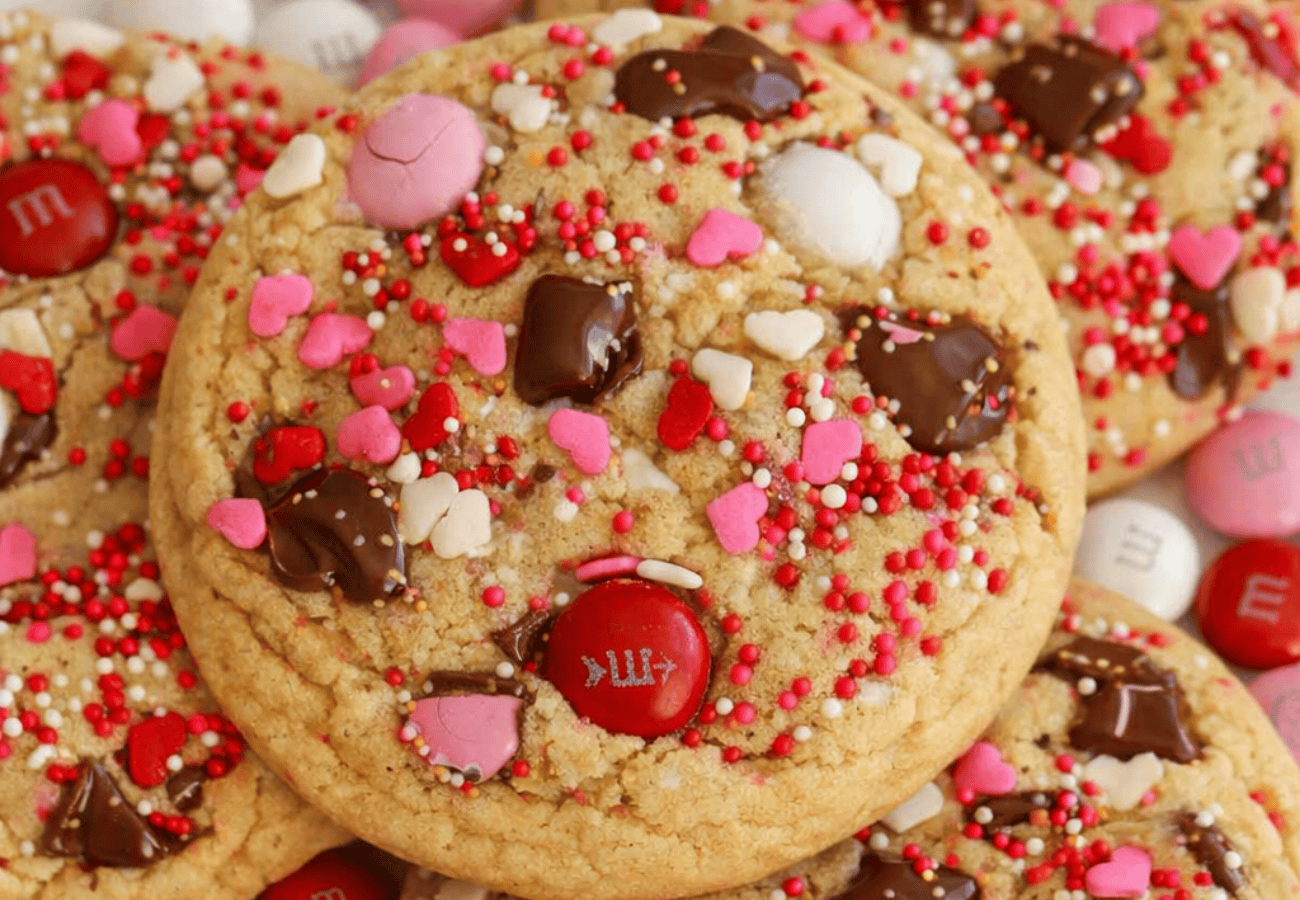 M&M Cookie topped with pink and red M&Ms and sprinkles.