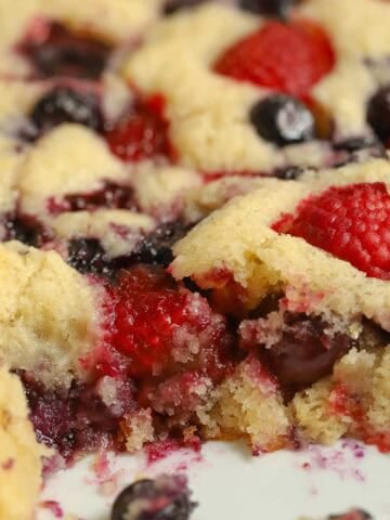 Cherry berry spoon cake in a white baking dish.