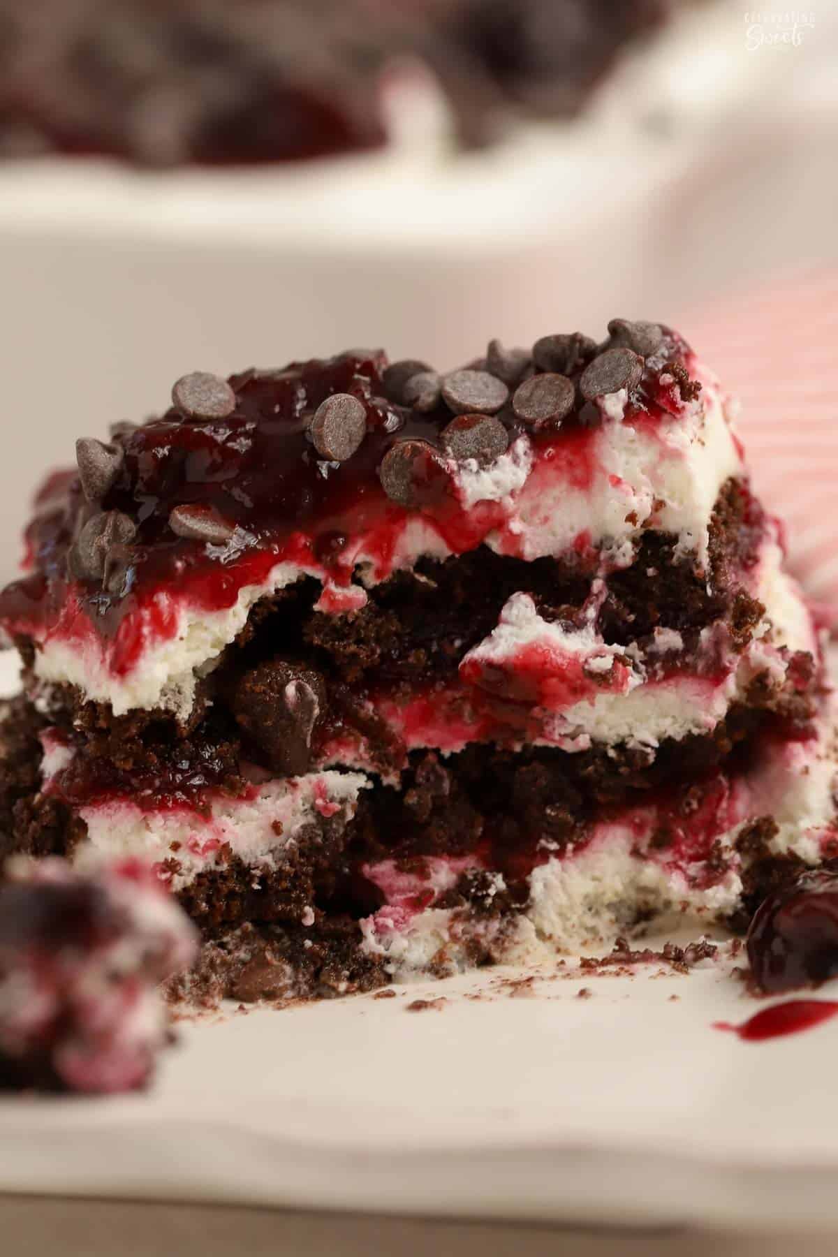A slice of black forest icebox cake with several bites removed.