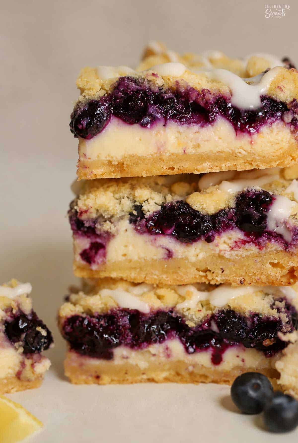 Closeup of a stack of three lemon blueberry crumb bars.